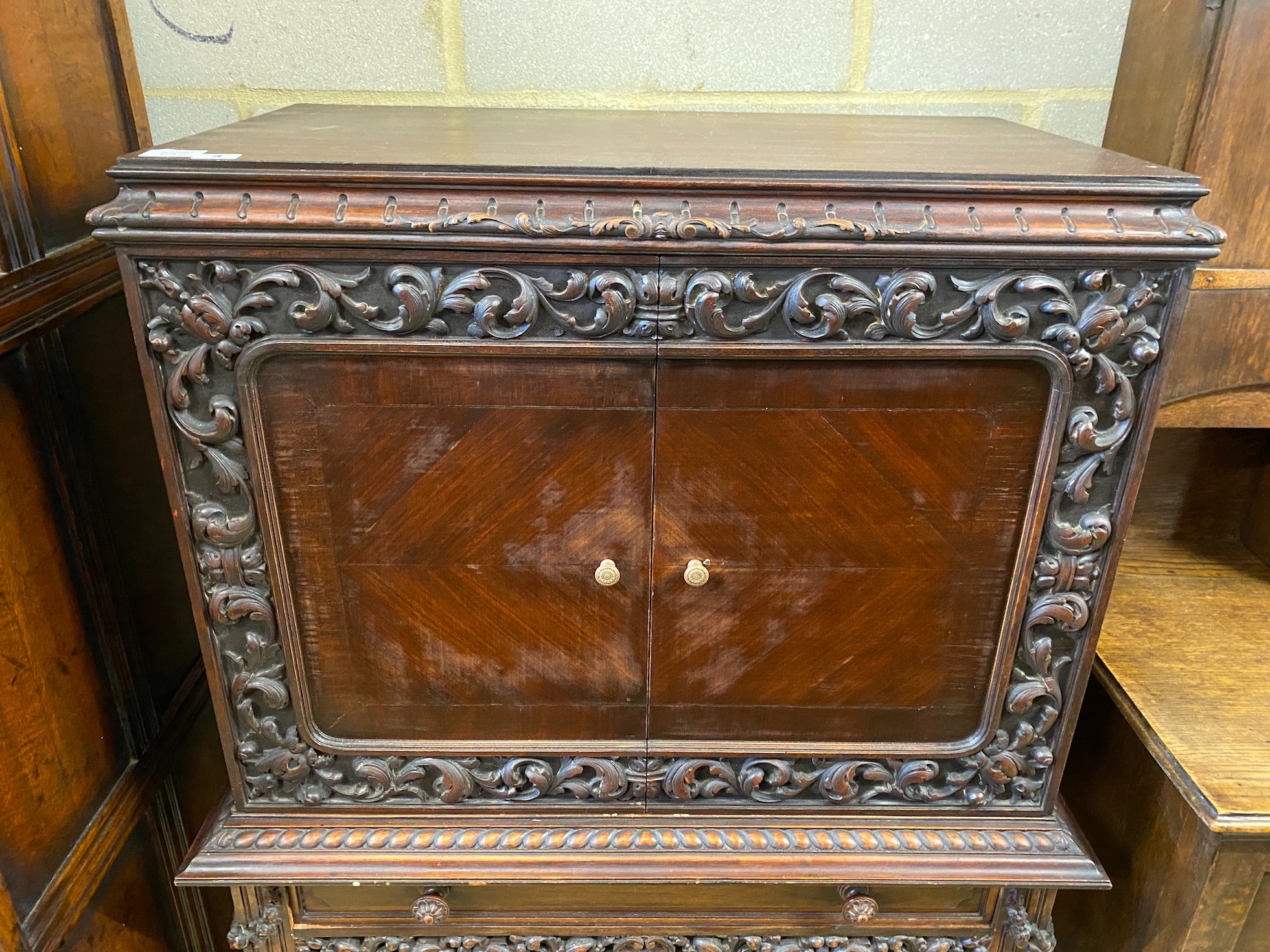 A 17th century style oak cocktail cabinet on stand, width 90cm, depth 50cm, height 137cm